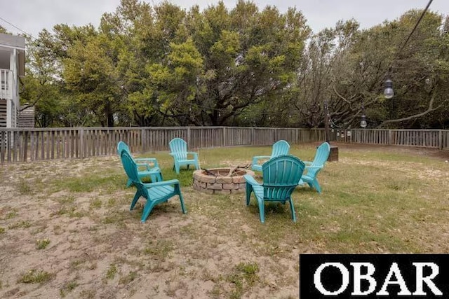 view of yard featuring an outdoor fire pit and a fenced backyard