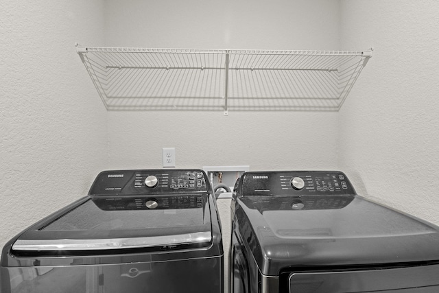 104 Garland St Lot 3, Moyock, NC 27958 - clothes washing area featuring a textured wall, washing machine and dryer, and laundry area