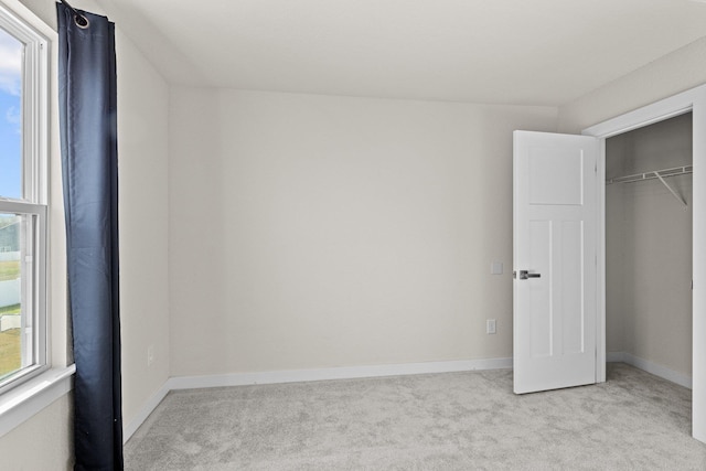 104 Garland St Lot 3, Moyock, NC 27958 - unfurnished bedroom with light carpet, baseboards, and a closet
