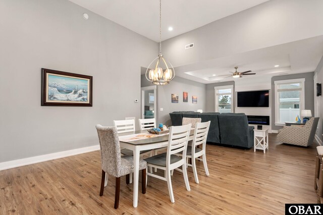 1304 Harpoon Dr Lot # 70, Kill Devil Hills, NC 27948 - dining room featuring light wood-style floors, a chandelier, recessed lighting, a raised ceiling, and baseboards