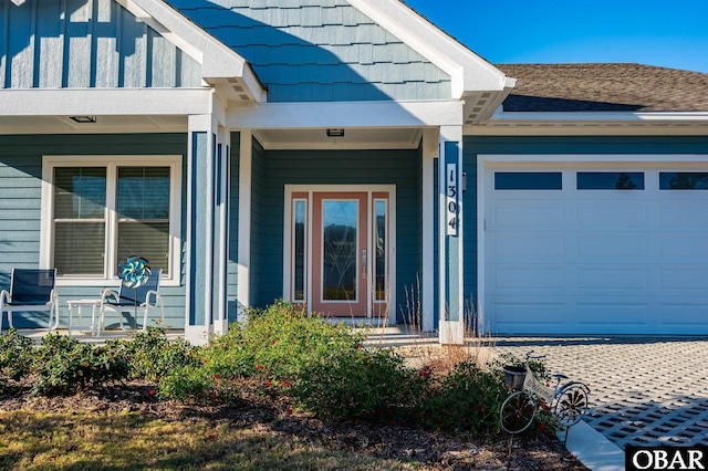 1304 Harpoon Dr Lot # 70, Kill Devil Hills, NC 27948 - doorway to property featuring a garage, covered porch, and board and batten siding
