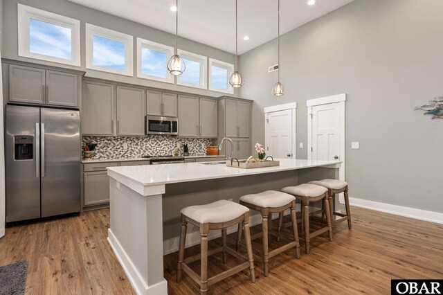 1304 Harpoon Dr Lot # 70, Kill Devil Hills, NC 27948 - kitchen with appliances with stainless steel finishes, gray cabinets, a high ceiling, a sink, and tasteful backsplash