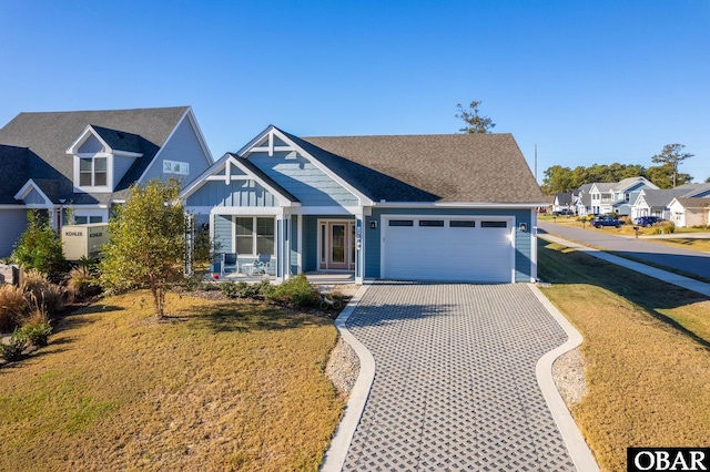 1304 Harpoon Dr Lot # 70, Kill Devil Hills, NC 27948 - view of front facade with a garage, a front lawn, driveway, covered porch, and board and batten siding