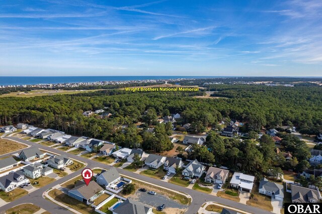1304 Harpoon Dr Lot # 70, Kill Devil Hills, NC 27948 - aerial view of property's location featuring nearby suburban area, a heavily wooded area, and a large body of water