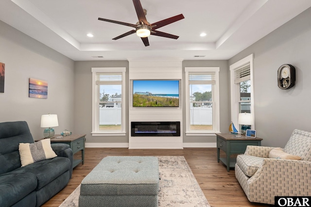 1304 Harpoon Dr Lot # 70, Kill Devil Hills, NC 27948 - living area featuring a raised ceiling, healthy amount of natural light, a ceiling fan, wood finished floors, and recessed lighting