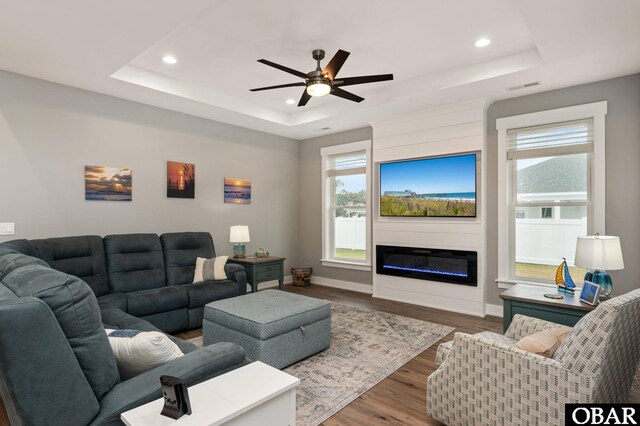 1304 Harpoon Dr Lot # 70, Kill Devil Hills, NC 27948 - living room featuring a tray ceiling, recessed lighting, healthy amount of natural light, ceiling fan, and wood finished floors