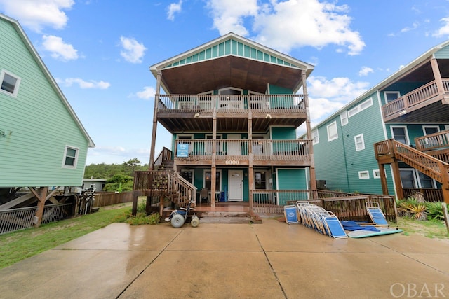 back of house featuring stairway