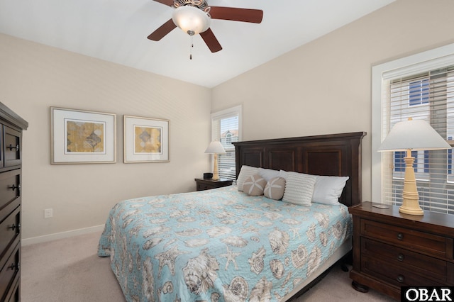 bedroom featuring baseboards, ceiling fan, and light colored carpet