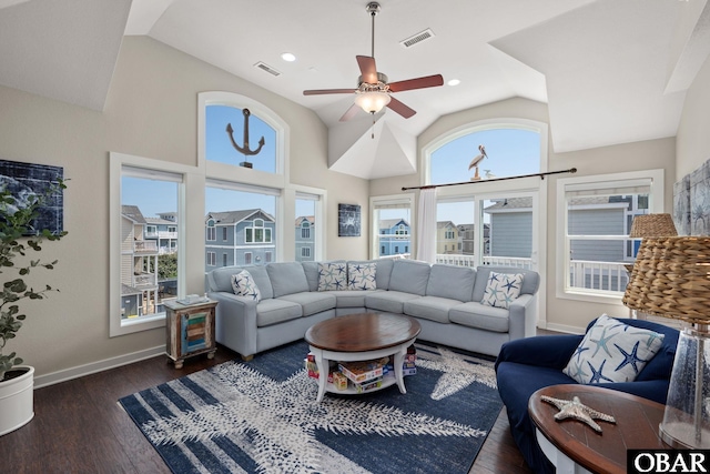 living room with dark wood-style floors, ceiling fan, visible vents, and baseboards