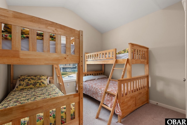 bedroom featuring lofted ceiling, baseboards, and carpet