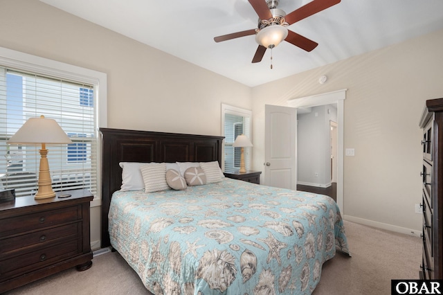 bedroom with light carpet, baseboards, and a ceiling fan