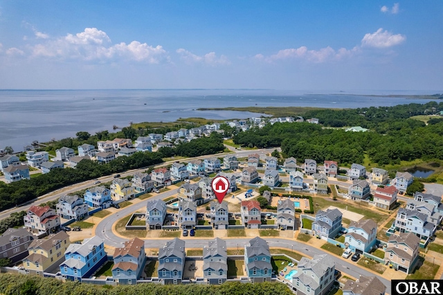 drone / aerial view with a water view and a residential view