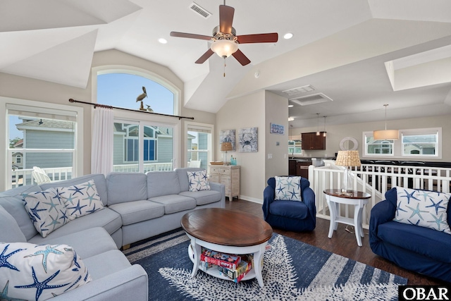 living area featuring lofted ceiling, visible vents, dark wood-type flooring, and recessed lighting