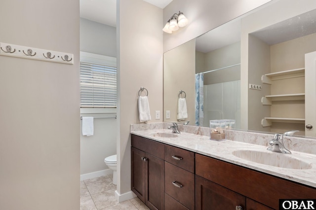 bathroom with toilet, double vanity, a sink, and tile patterned floors