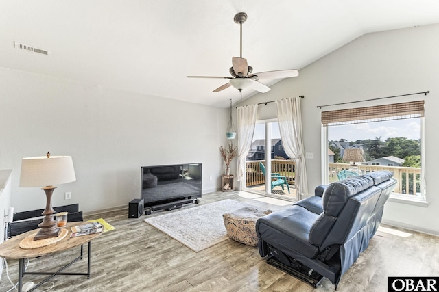 living room featuring lofted ceiling, wood finished floors, a ceiling fan, and baseboards