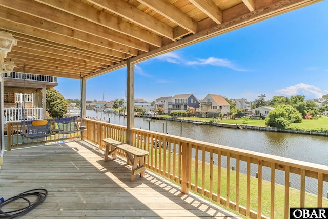 wooden deck with a water view and a residential view