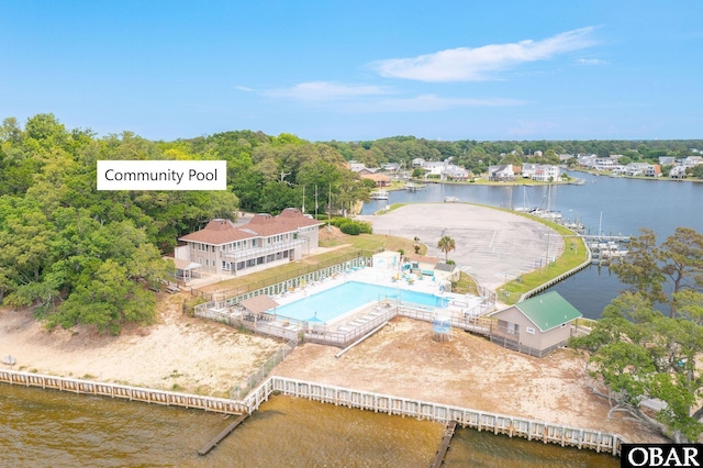 bird's eye view of a nearby body of water and a pool