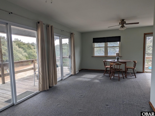 dining room featuring carpet, baseboards, and a ceiling fan