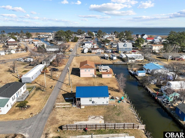 drone / aerial view with a water view and a residential view