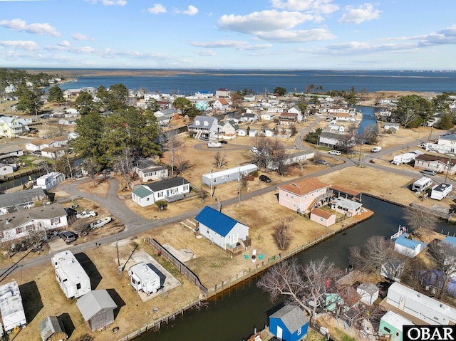 drone / aerial view featuring a water view and a residential view