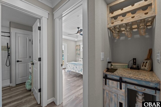 bathroom featuring a ceiling fan and wood finished floors