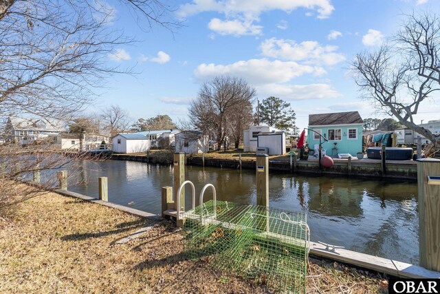 view of dock featuring a water view and a residential view