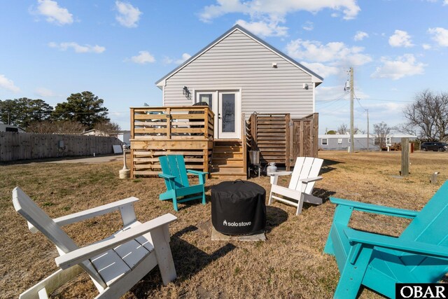 back of property with a yard and fence