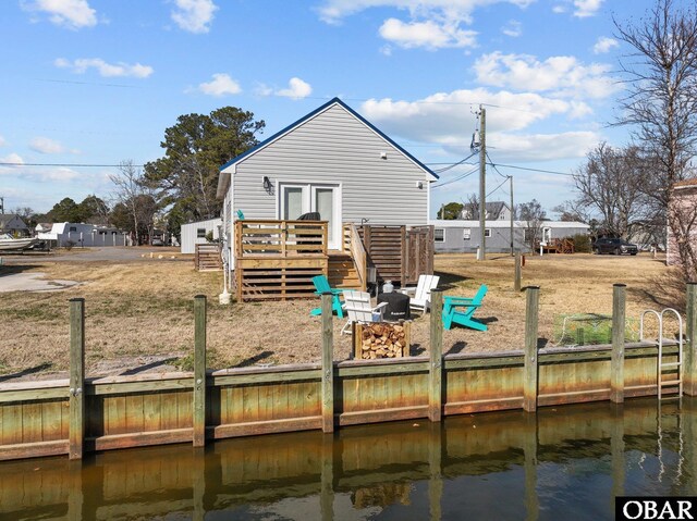 rear view of property featuring a deck with water view