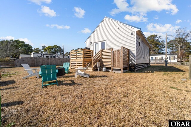 view of property exterior with fence private yard and a lawn