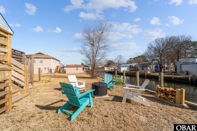 view of yard with a residential view and a water view