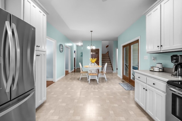 kitchen with stainless steel appliances, white cabinetry, and light countertops