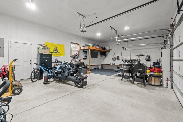 garage featuring electric panel and a garage door opener