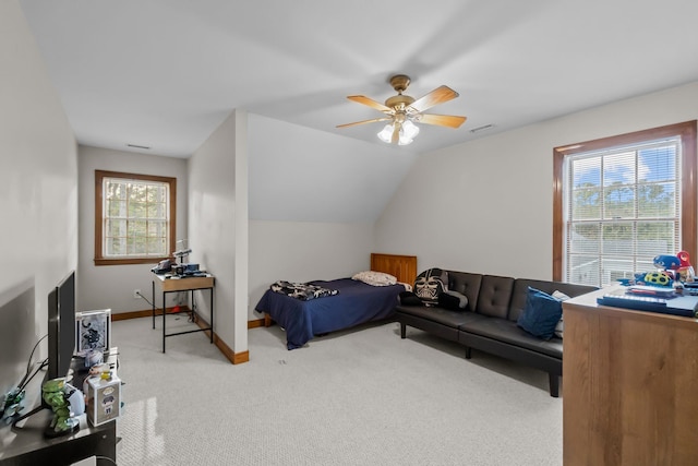 bedroom with a ceiling fan, visible vents, baseboards, vaulted ceiling, and light colored carpet