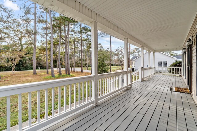 wooden terrace featuring covered porch