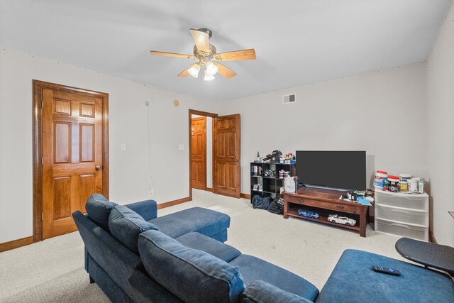 living area with visible vents, a ceiling fan, baseboards, and carpet floors