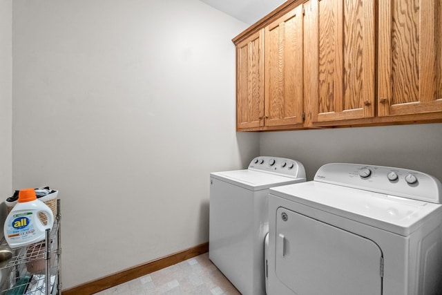 laundry area with baseboards, cabinet space, and washer and clothes dryer