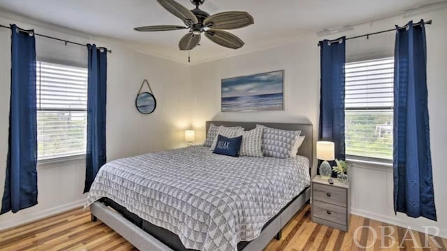 bedroom with light wood-type flooring and a ceiling fan