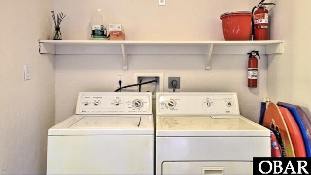 clothes washing area with laundry area and independent washer and dryer