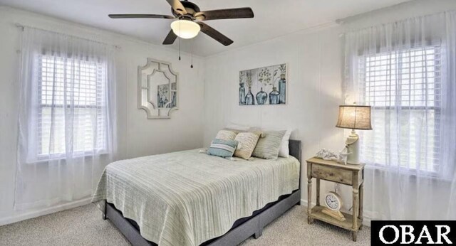 carpeted bedroom featuring a ceiling fan and multiple windows