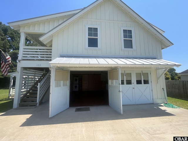 102 Daybreak Ct Lot # 53, Grandy, NC 27939 - view of front of home with a standing seam roof, driveway, stairway, and board and batten siding