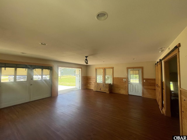 102 Daybreak Ct Lot # 53, Grandy, NC 27939 - unfurnished living room with a barn door, wainscoting, and wood finished floors