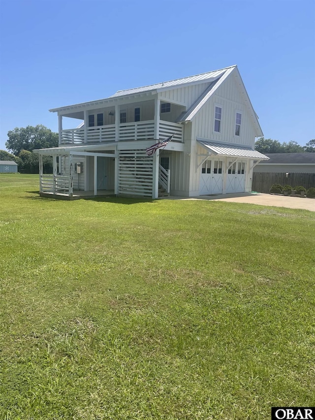 102 Daybreak Ct Lot # 53, Grandy, NC 27939 - view of front facade featuring an attached garage, a front yard, a metal roof, concrete driveway, and board and batten siding