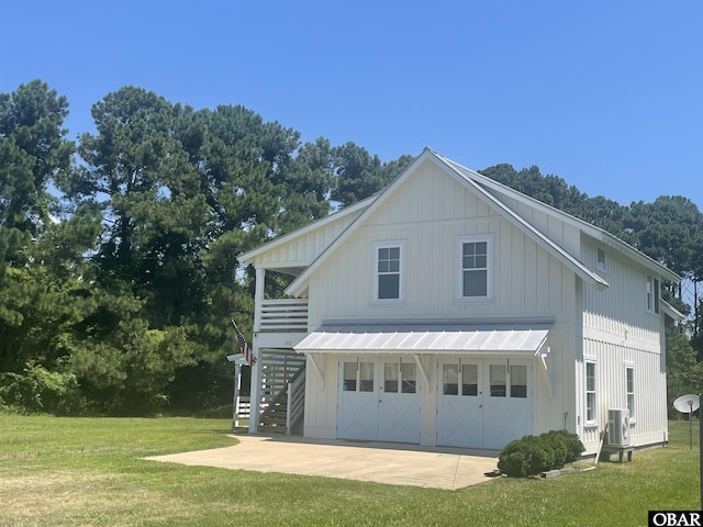 102 Daybreak Ct Lot # 53, Grandy, NC 27939 - view of front of home featuring stairs, a front yard, board and batten siding, and a garage