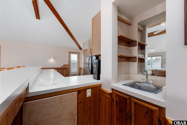 629 Sanderling Trl Lot 51, Corolla, NC 27927 - kitchen with a sink, light countertops, freestanding refrigerator, brown cabinetry, and open shelves