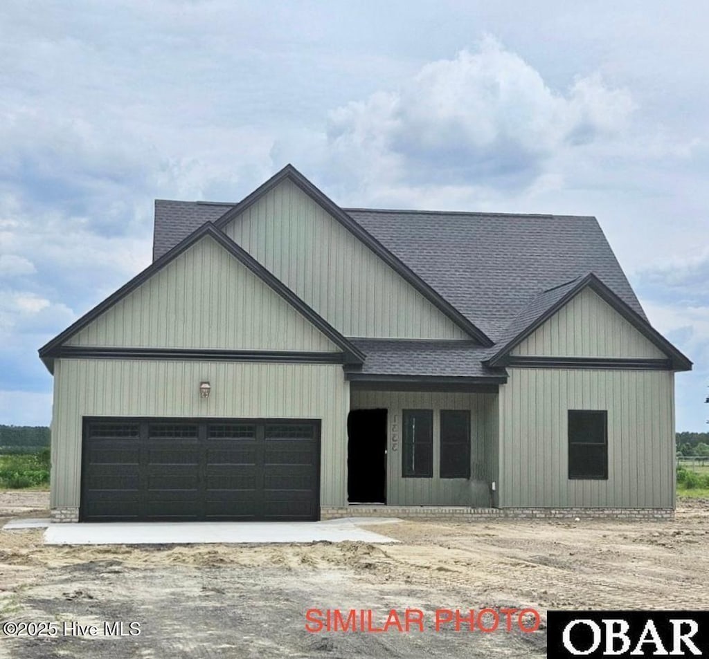 view of front of home featuring a shingled roof and an attached garage