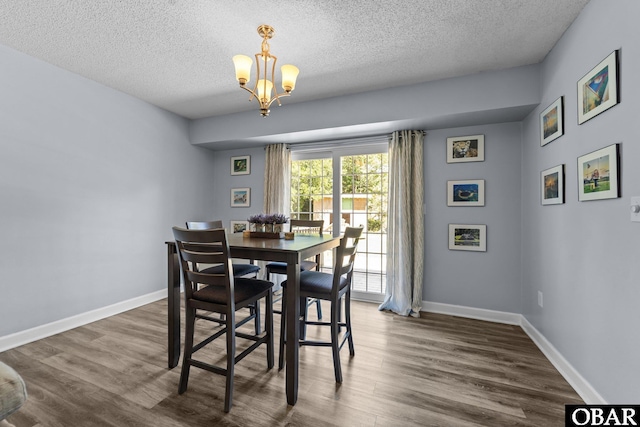 1095 Burnside Rd Lot B3, Manteo, NC 27954 - dining room with dark wood-style flooring, a textured ceiling, a chandelier, and baseboards