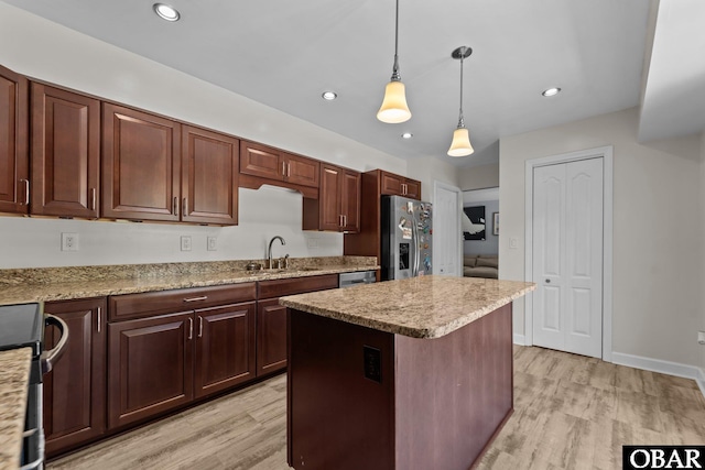 1095 Burnside Rd Lot B3, Manteo, NC 27954 - kitchen with a sink, stainless steel appliances, light wood-style floors, hanging light fixtures, and a center island