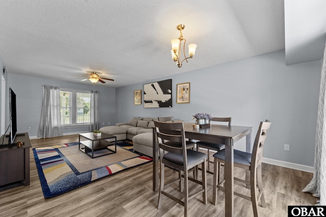 1095 Burnside Rd Lot B3, Manteo, NC 27954 - dining room featuring wood finished floors, a textured ceiling, a chandelier, ceiling fan, and baseboards