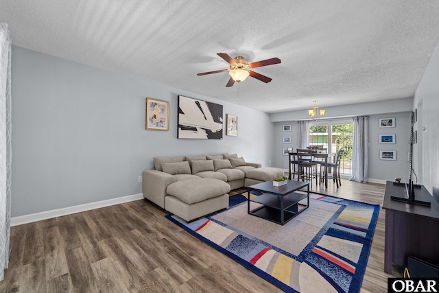 1095 Burnside Rd Lot B3, Manteo, NC 27954 - living room with a textured ceiling, a ceiling fan, wood finished floors, a chandelier, and baseboards