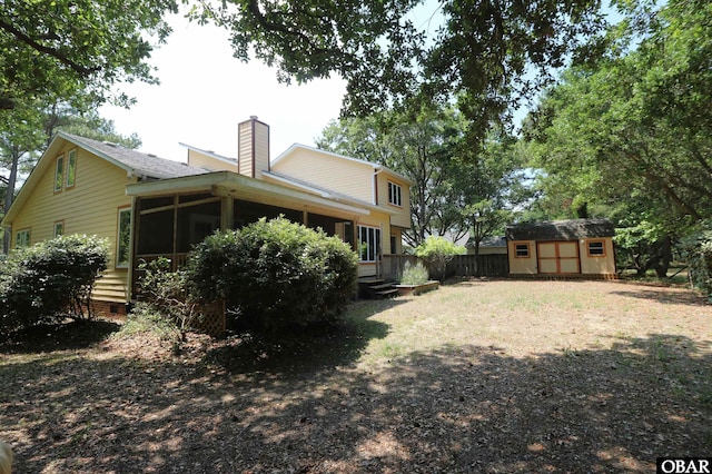 509 Telegraph Ct Lot 17, Kill Devil Hills, NC 27948 - rear view of house with a sunroom and a chimney